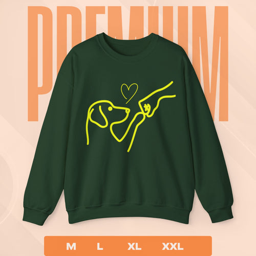 Green sweatshirt with yellow dog and person graphic on a peach background