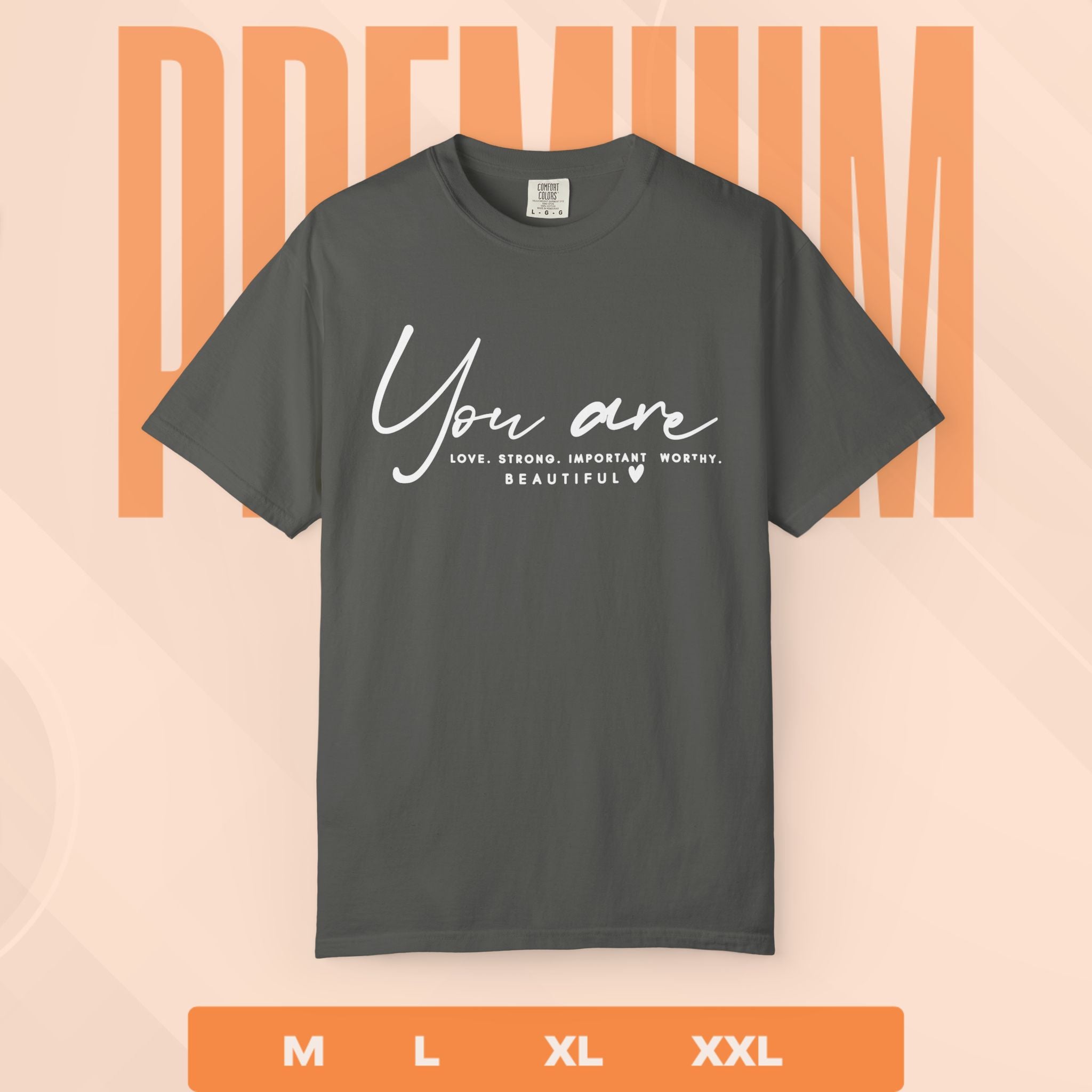 Gray t-shirt with motivational quote on a peach background