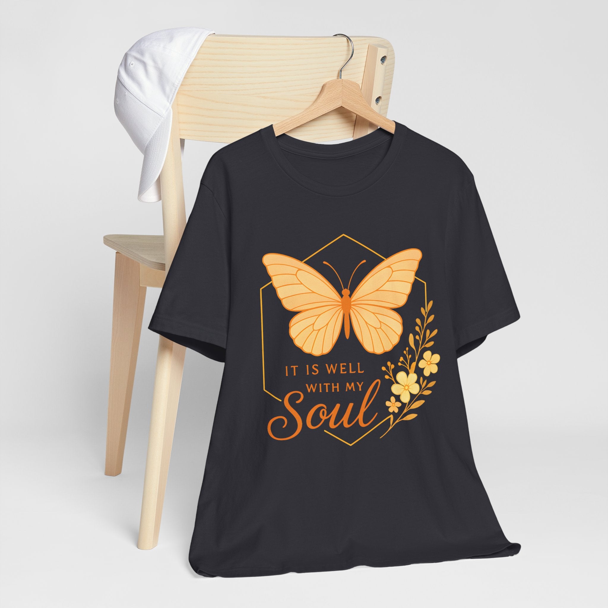 Black t-shirt with orange butterfly graphic and 'It is well with my soul' text on a white background.