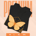 Black t-shirt with a yellow butterfly design on a peach background with 'PREMIUM' text.