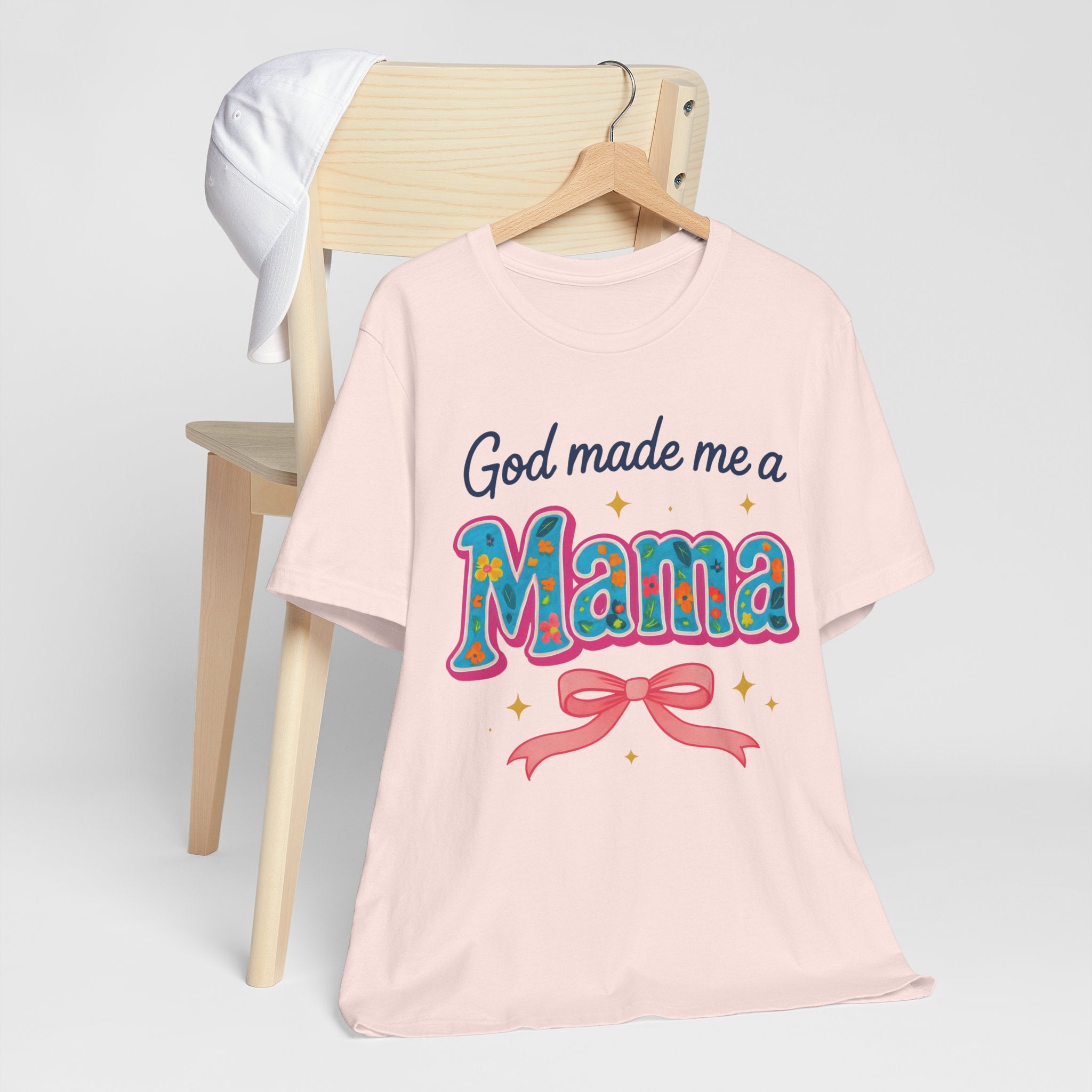 Pink t-shirt with 'God made me a Mama' text on a white background