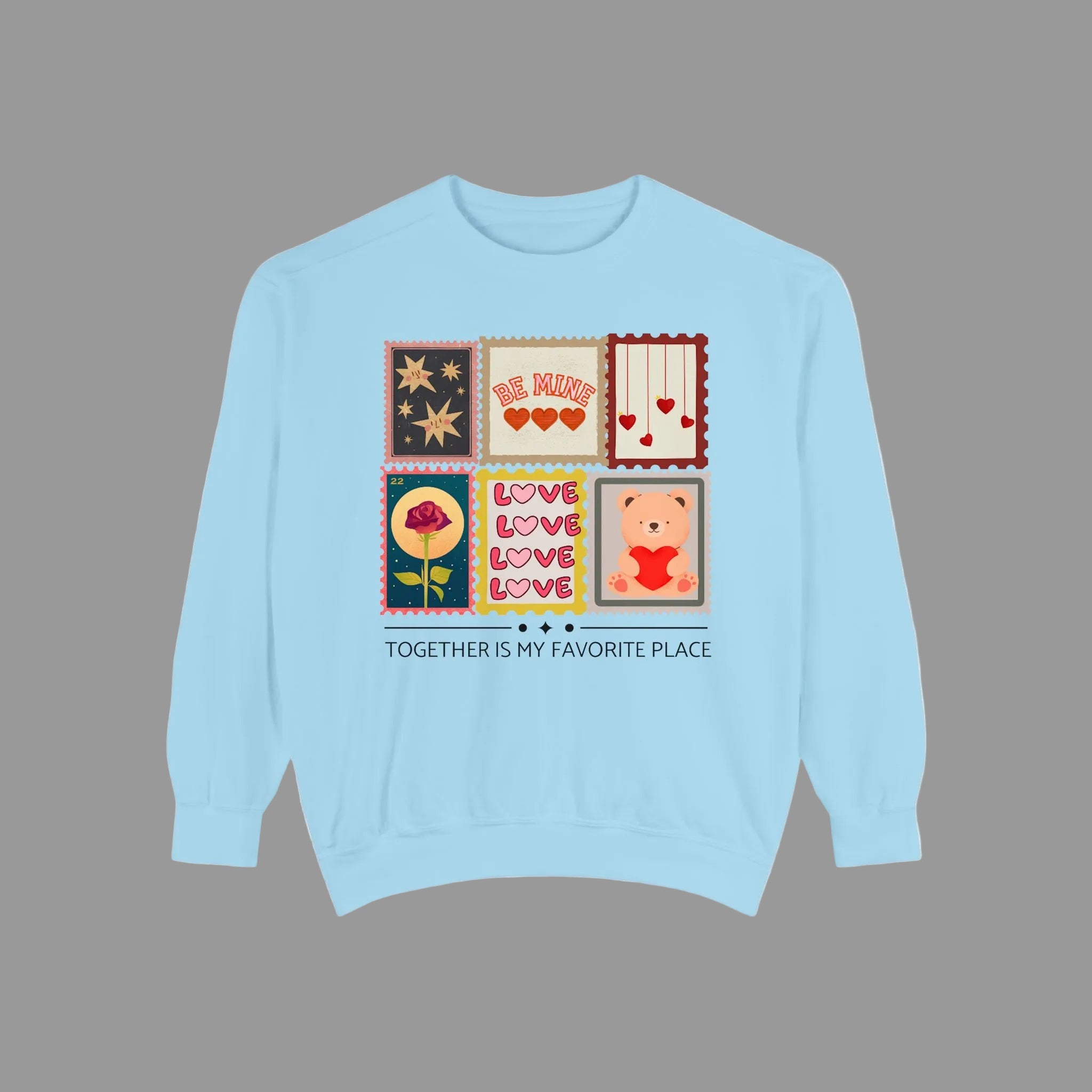 Light blue sweatshirt with graphic designs and text on a white background