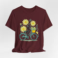 Marroon t-shirt with a bicycle and flower design on a white background