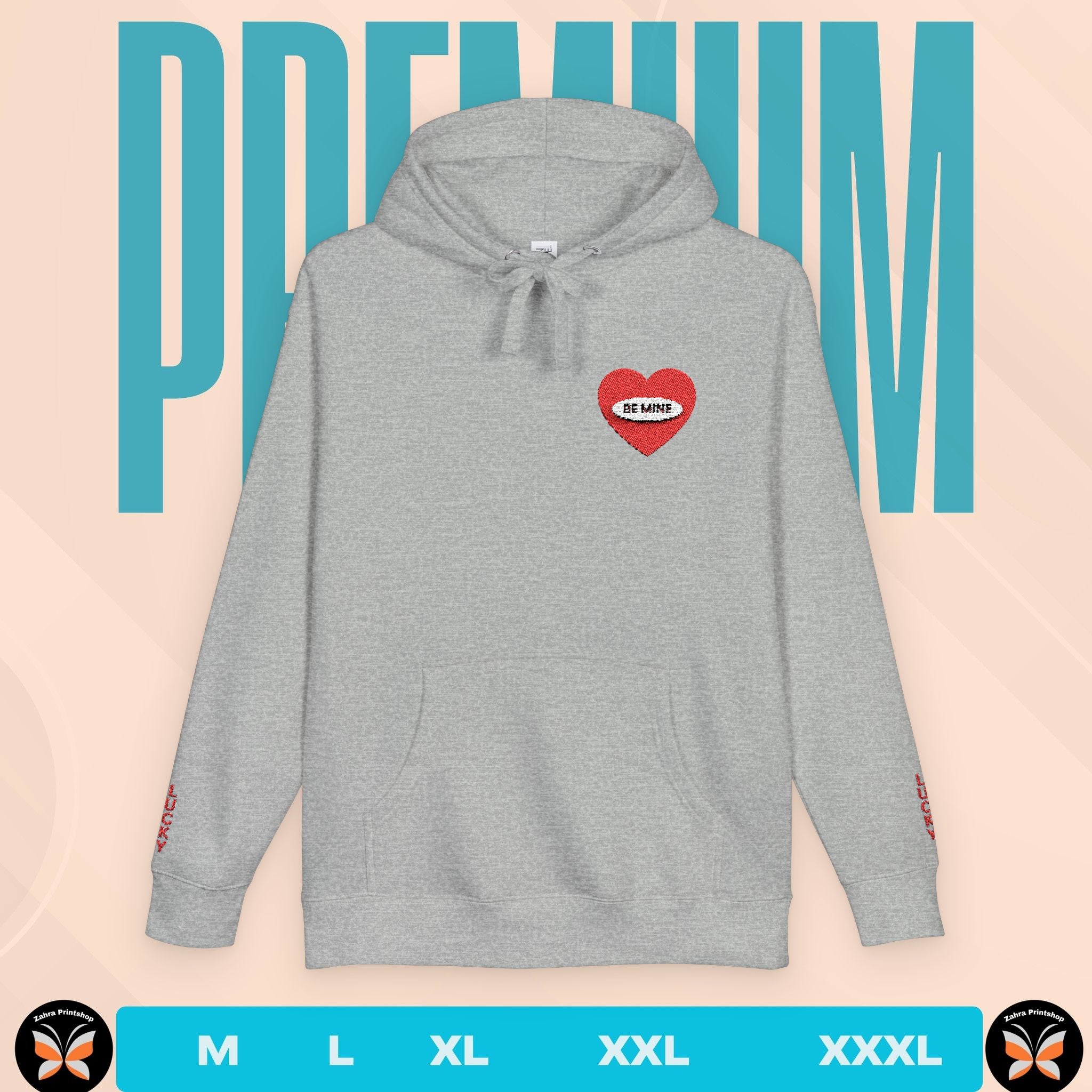 Gray hoodie with a red heart design on a beige background with 'PREMIUM' text.