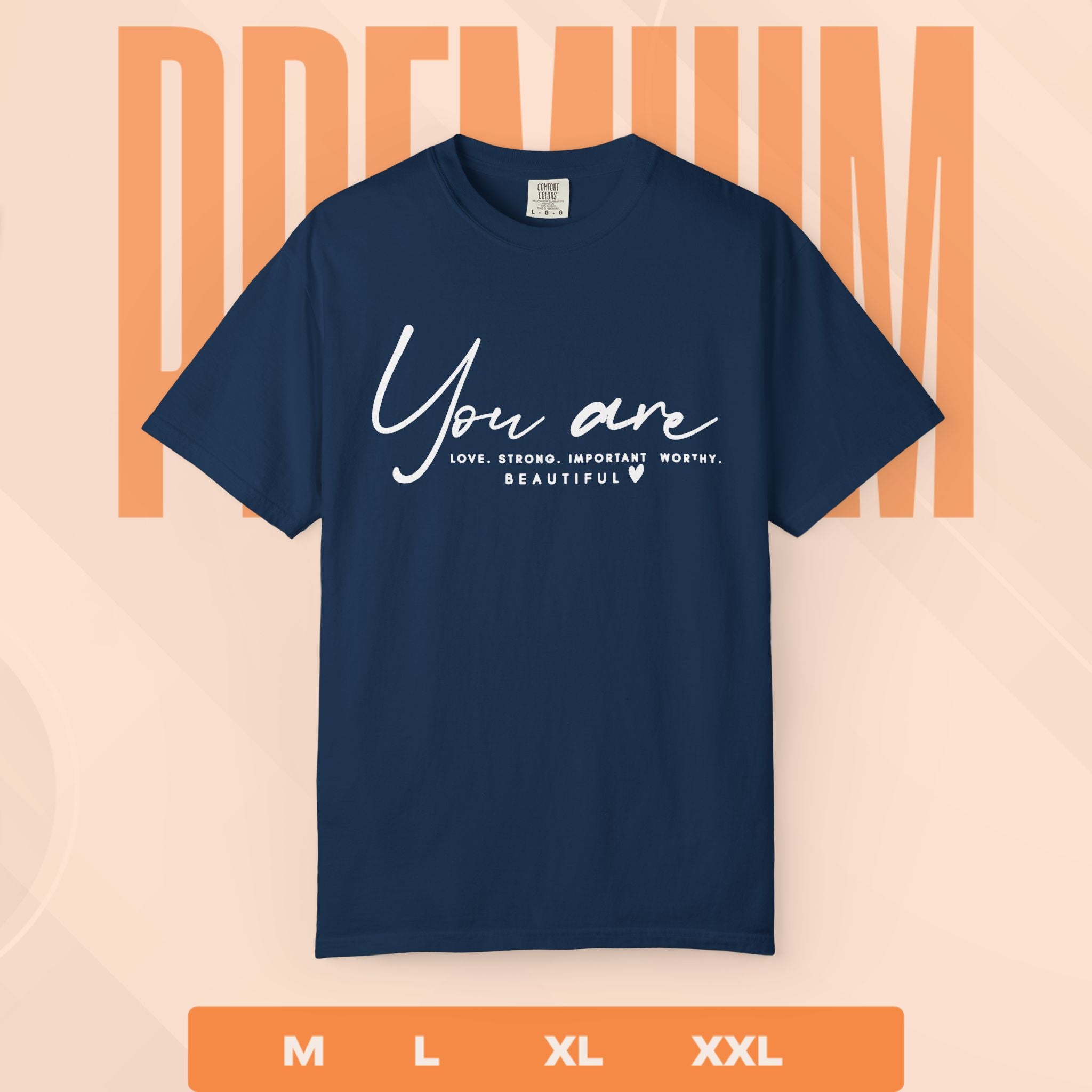 Navy blue t-shirt with motivational quote on a peach background