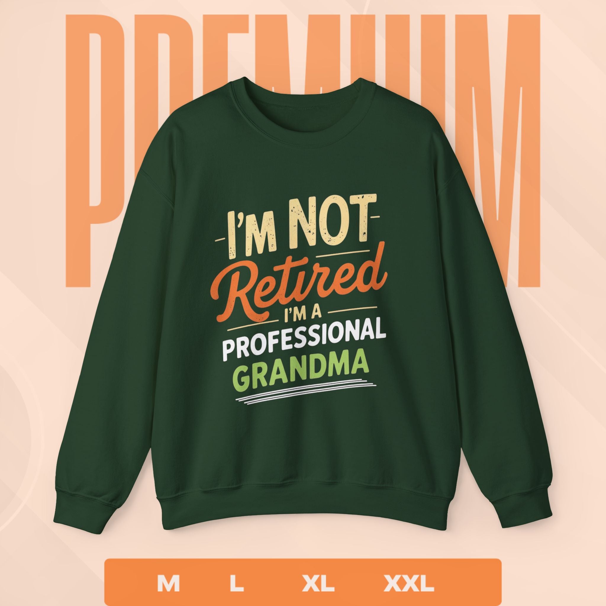 Green sweatshirt with text 'I'm not retired, I'm a professional grandma' on a peach background.