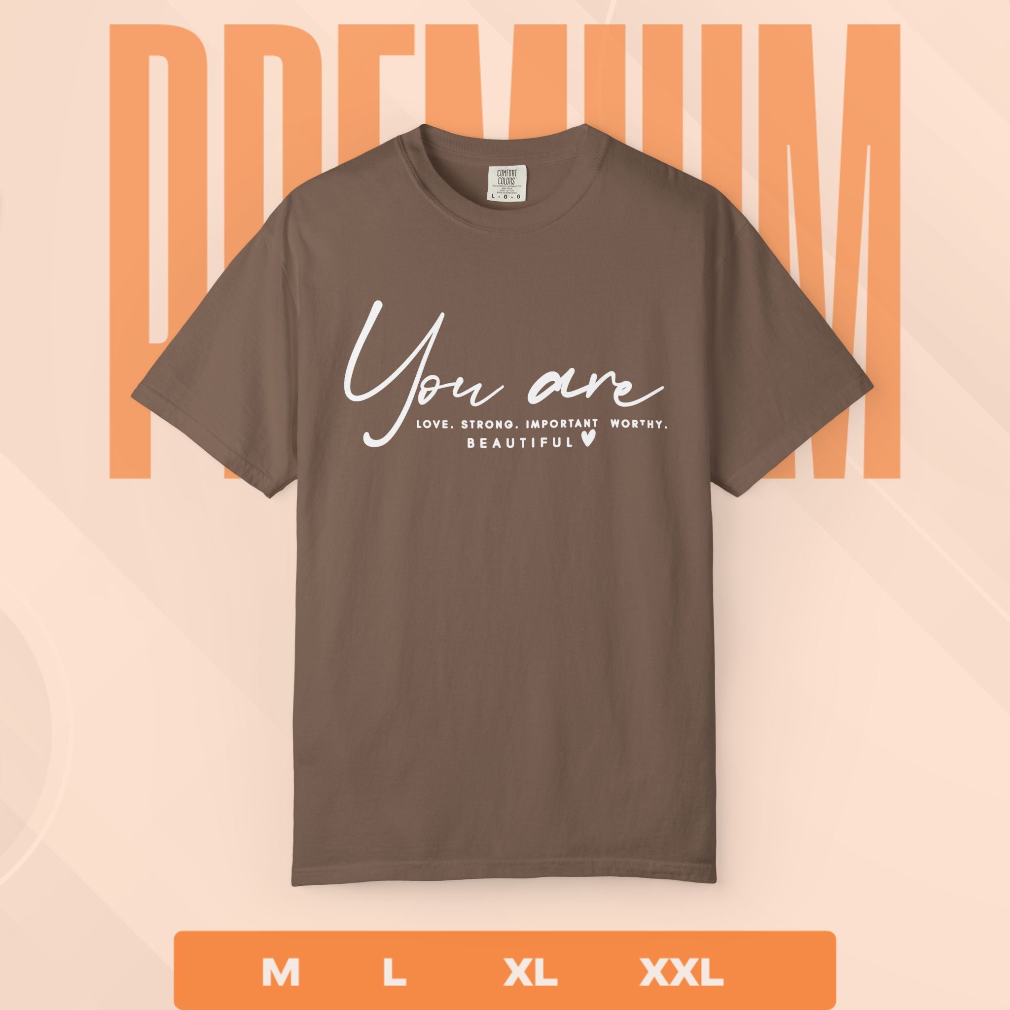 Brown t-shirt with motivational quote on a peach background