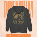 Black hoodie with a kayak graphic and text on the back, displayed against a peach background with 'PREMIUM' text.