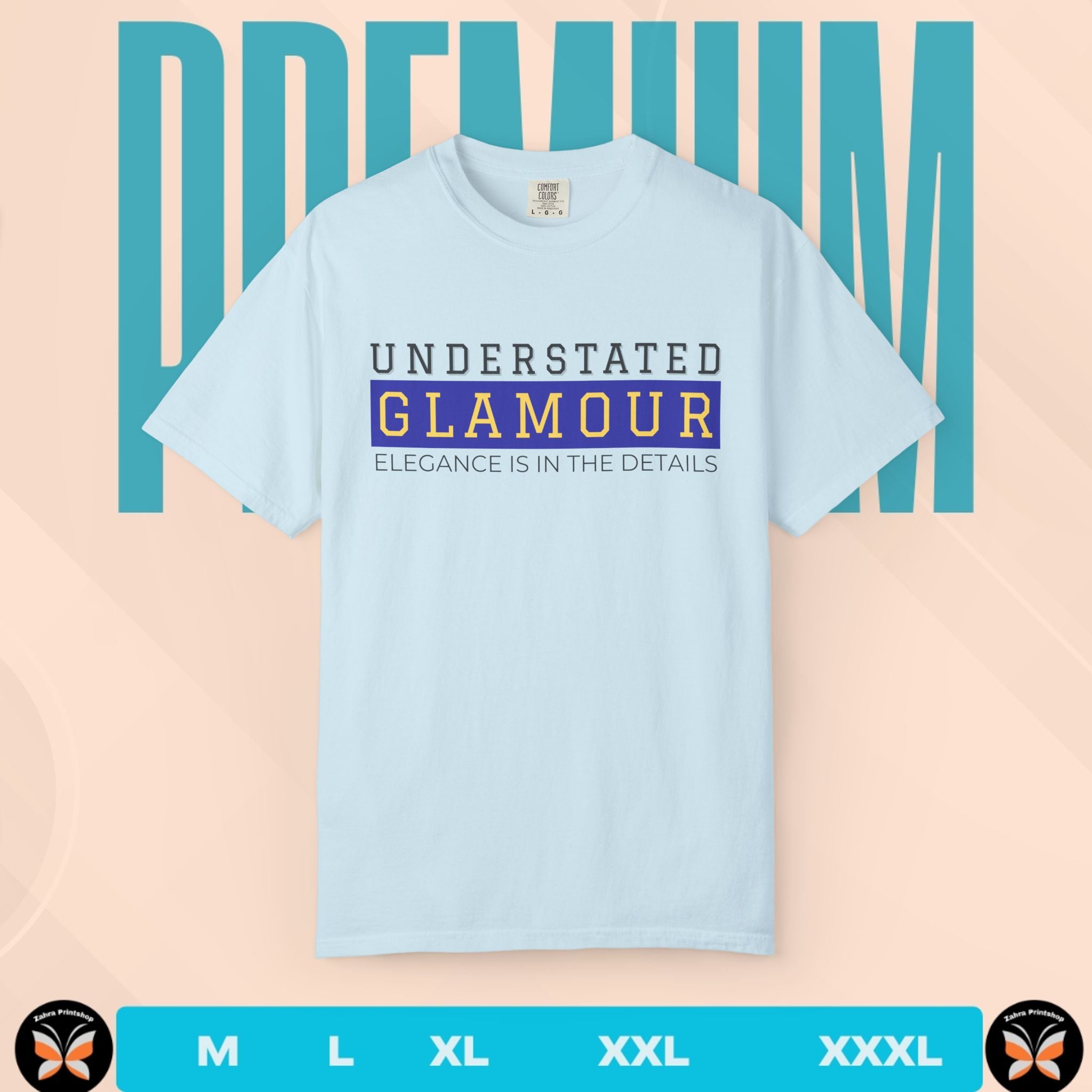 Light blue t-shirt with 'Understated Glamour' text on a peach background