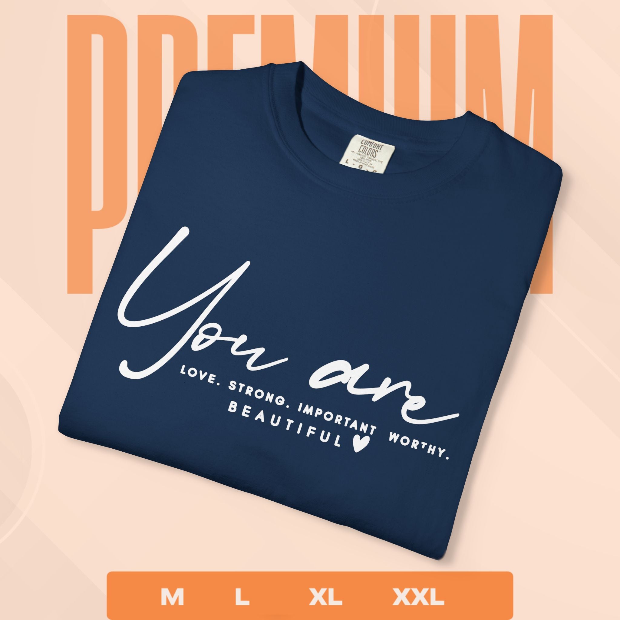 Navy blue t-shirt with motivational quote on a peach background