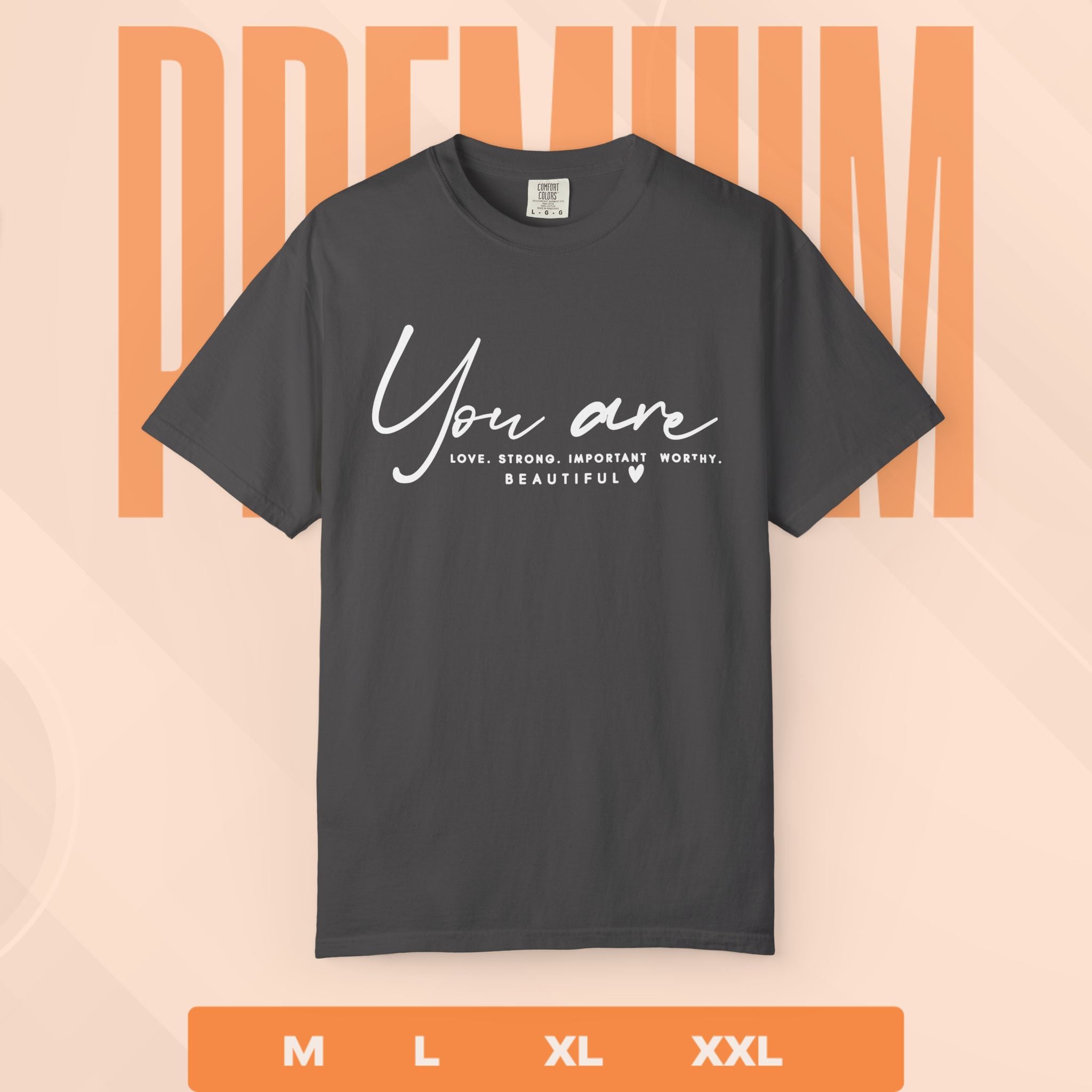 Black t-shirt with motivational quote on a peach background