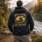 Person wearing a hoodie with 'Kayaking Gets Me Wet' design in a natural setting.